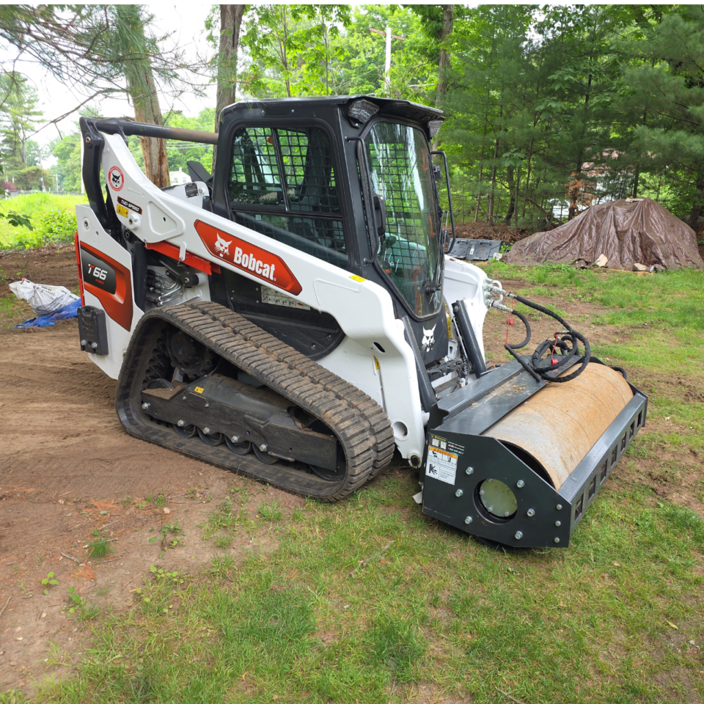 Bobcat skid steer grading a residential driveway in Worcester County