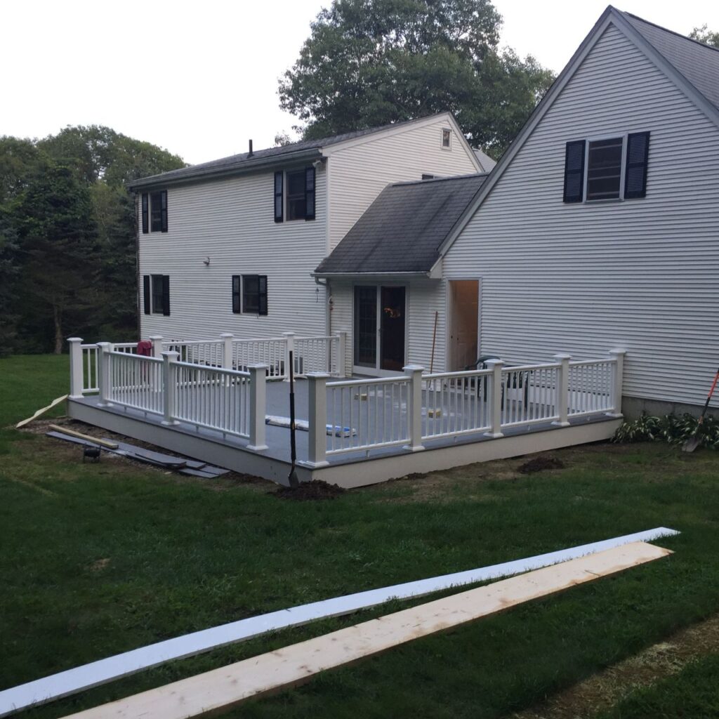 deck replacement finished with composite boards and white railings in Central Massachusetts