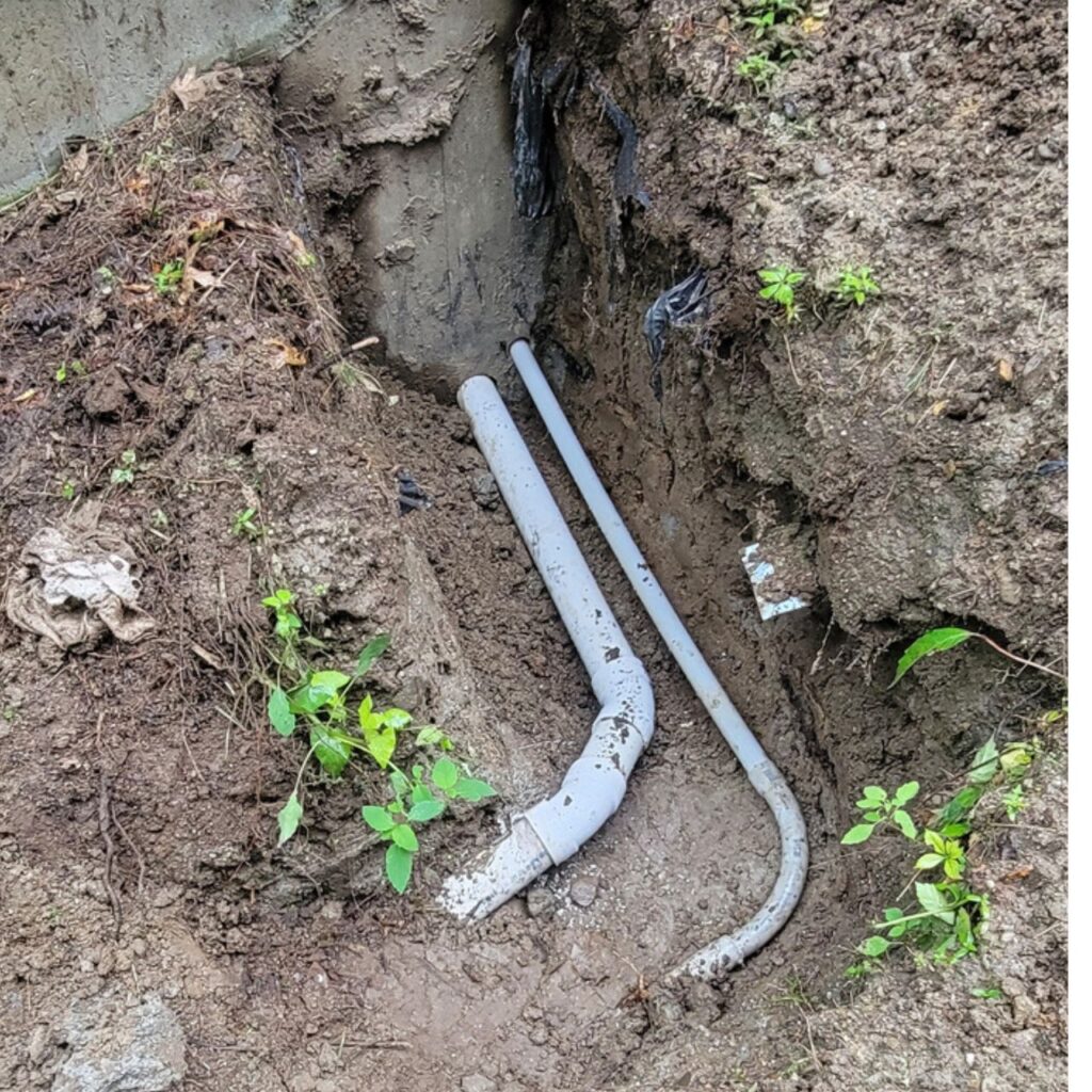 Yard drainage outlet discharging at a bank in Central Massachusetts