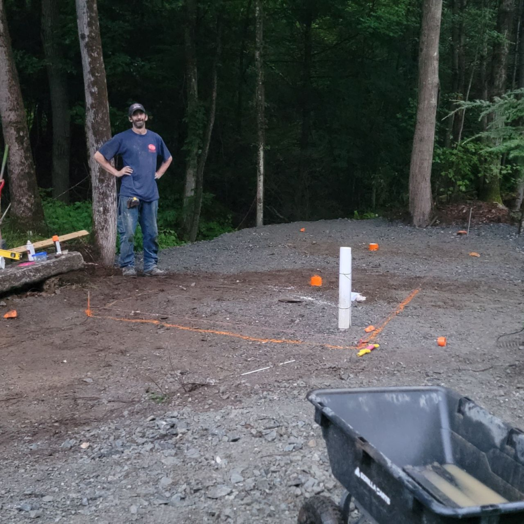 Building site preparation with a compacted pad laid out and marked on a Central Massachusetts property