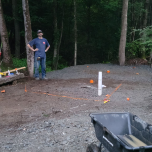Building site preparation with a compacted pad laid out and marked on a Central Massachusetts property