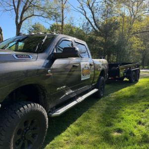 Material hauling and removal truck and dump trailer at a Central Massachusetts property