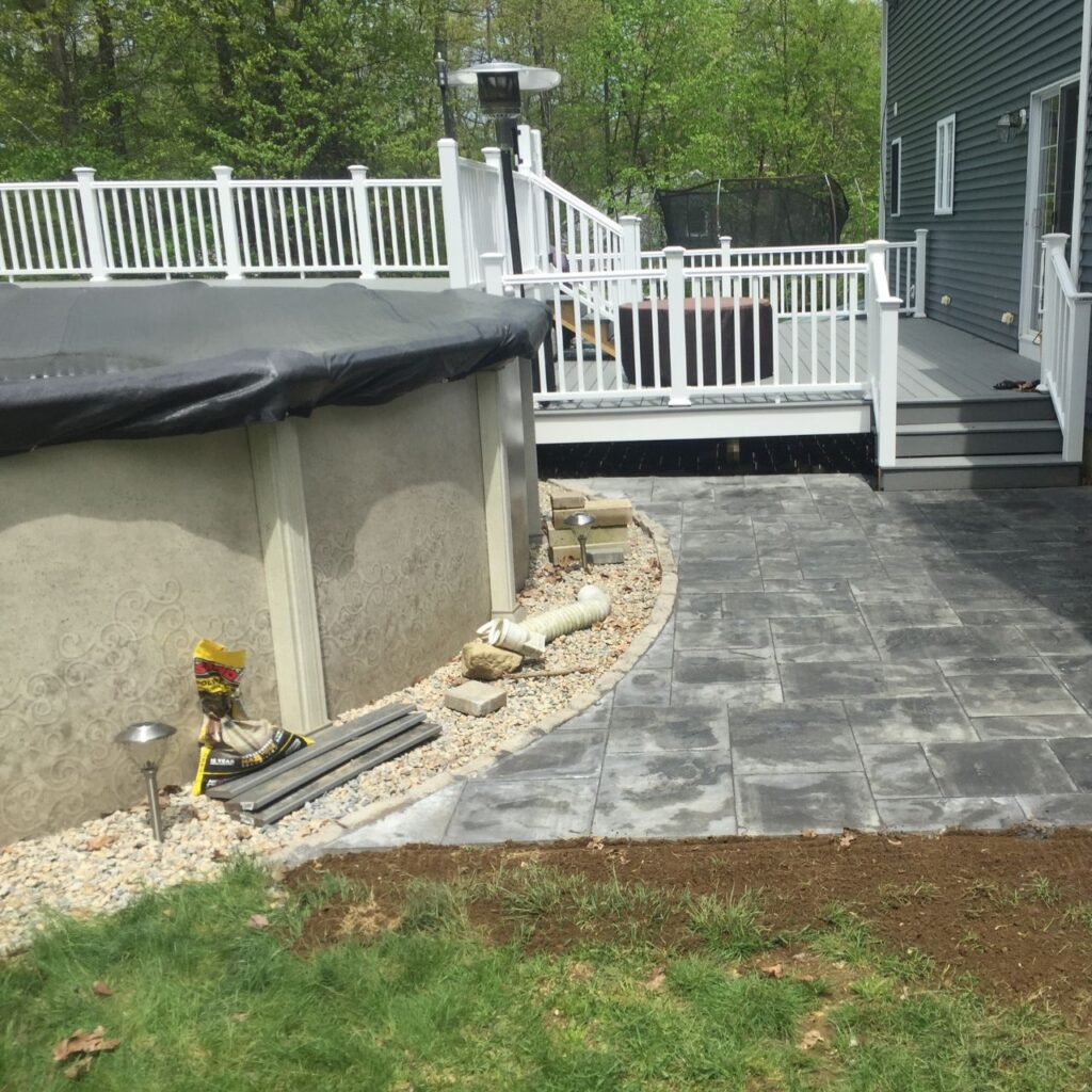 Project coordination on a finished Central Massachusetts property improvement with a paver patio, deck, and stone edge
