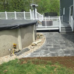 Project coordination on a finished Central Massachusetts property improvement with a paver patio, deck, and stone edge